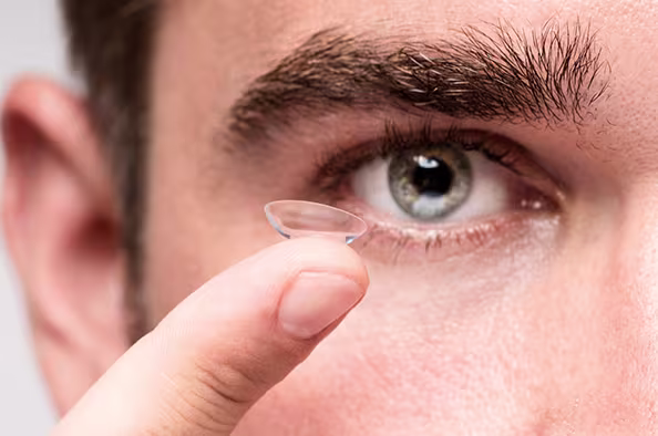Ophthalmology Associates contact lens rebates promotion featuring patient holding contact lens for affordable vision care savings