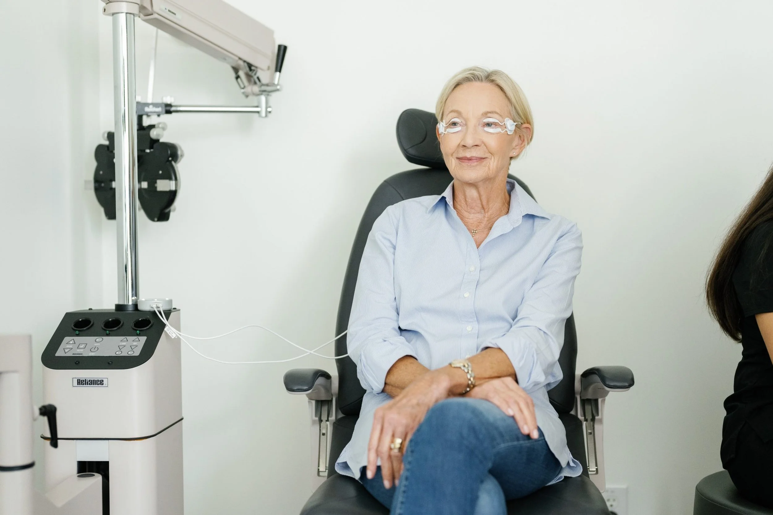 Patient receiving TearCare dry eye treatment in an ophthalmology clinic for meibomian gland dysfunction relief